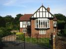 Mandarin House: large mock-tudor house with wrought-iron gates.