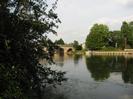 River Thames with Maidenhead Bridge on the left.
Large trees on the far bank partly hiding two derelict houses.
Moored boat.