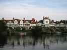 River Thames, with Gaiety Row houses on the far side.
Most houses are white painted with some black timbers, and have red tile roofs.
Steep gardens lead down to the river.
