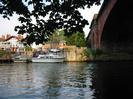 River Thames and railway bridge.
Houses and moored boats on the far bank.