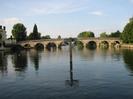 River Thames.
Channel marker post in foreground, with Maidenhead Bridge behind it.
Hotel building and trees on left.
Trees and moored boat on right.