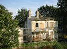 Derelict houses with scaffolding.
Large trees.