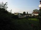 Dark bushes in foreground.
Top of old boatyard crane on left.
Upper part of Thames Riviera Hotel on far bank of river.
Rowing Club building on right.
