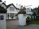 Bridge Cottage guest house and B&B.
White building with black and white window frames, several chimneys, and a dark roof.
Large white pillars each side of entrance, with lamps on top.
English Tourism Council sign on left-hand pillar.
Sign advertising Bridge Cottage guest house and B&B on right-hand pillar.