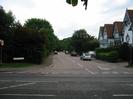 Road junction, looking across the A4 Bath Road into Ellington Road.
40mph sign and road-name sign for Ellington Road in grass verge on left.
Cars on Ellington Road.
Row of three-storey houses on right.