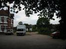 Old Court Hotel car-park.
Hotel building on left.
Parked vehicles.
Overhanging trees.