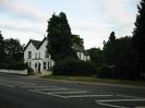 Looking across the A4 Bath Road.
White house with black doors and dark slate roofs.