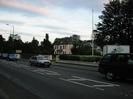 Road with cars.
Large house set back from road, with sign "Silchester House School"
Low walls with hedges alongside road.
Flagpole.
Sign on right for Norfolk House Hotel.