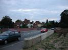 Road and bridge with temporary traffic barriers.
Houses in distance.