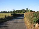 Looking north on Hitcham Road.
High hedges on both sides.
Car in the distance.