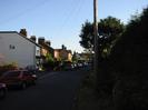 Looking south on Hitcham Road.
Houses on the left.
Grass verge with hedge and telephone pole on the right.