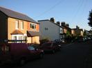 Houses on the left of the road, mostly in red brick.