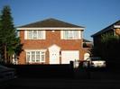 Brick house with white doors and windowframes.