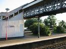 Island platform with iron footbridge and steps.