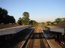 Platforms 4 and 3 seen from the footbridge.
Station buildings on each side with canopies.
Trees in the background.