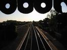 Looking west from the footbridge into the setting sun.
Part of bridge roof at top of picture.
Sun glinting off the relief line below.
Main line on left joins with relief line in the distance.