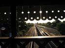 Looking west along the main line, into the setting sun.
Light glinting from rails.
Row of lights glistening.
