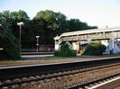 Island platform, footbridge, bike shelter.
Bushes and trees.
Lamp-posts.