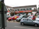 Station Garage Taplow Mitsubishi showroom.
Two-storey building with windows set into tile roof.
Cars on forecourt.
Back of roadsign on left.