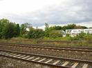 Railway tracks with SGT buildings visible in the background.