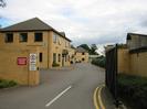 Bishops Gate offices.
Two-storey buildings of sandy-coloured brick with dark tile roofs.
Signs on wall: "CAUTION LORRIES TURNING" "5 MPH" "ALL CONTRACTORS PLEASE REPORT TO THE MANAGEMENT OFFICE"
Sign on first building: "Creative Computing Solutions Ltd"
Estate-agents' signs on far buildings.