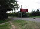 The northern end of Marsh Lane.
Wide grass verge with footpath.
Trees on left.
Sign in verge "No access to Dorney Lake construction traffic".
National speed-limit sign.