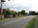 Looking south on Marsh Lane.
Grass verge on near side.
Houses behind walls on the far side.