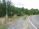 Looking north on Marsh Lane.
Road with footway and hedge on left.