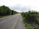 Looking south on Marsh Lane.
Road on left. Footway and hedge on right.