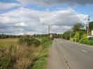 Looking north on Marsh Lane.
Field and hedge on left.
Road on right.