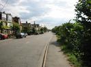 Looking south on marsh Lane.
Houses on left.
Road with footway and hedge on right.
