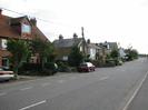 Road with houses on the left.