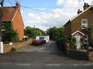 Entrance to Mitie Generation yard.
Houses on each side of the access road.