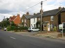 Road with mixed row of houses on th far side.