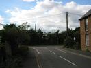 Looking west along Ye Meads, towards junction with Marsh Lane.
Road with footway each side.
Brick building on right.