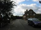 Looking west on Ye Meads.
Road with footway each side.
Large brick building on right.