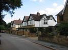 Two pairs of semi-detached houses with brick at ground-floor level and white painted render above.