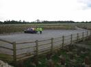 Gravel car park with wooden fence.