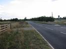 Looking south on Marsh Lane.
Fence and scrubby grass on left.
Footway and trees on right.