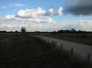 Gravel track with row of posts alongside.