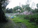 Pile of rubble surrounded by trees.
