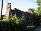 White Place Lodge: stone-built house with stone roof.
Telephone pole on left.