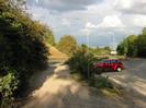 Lane leading to main road.
Car-park on right.
Tall street-lights.