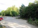 Car park with entrance to Thames Valley Adventure Playground.
Trees on right.