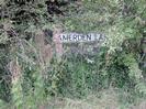 Road-name sign for Amerden Lane.
Sign almost lost in bushes.