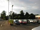 Altwood car dealership.
Bath Road on the left, with traffic lights at junction with Berry Hill.
Low brick wall alongside pavement.
Cars on dealer's forecourt.