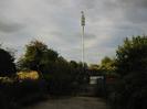Looking north across Approach Road.
Low trees and cellphone mast.