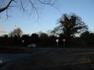 The A4 Bath Road with bank of dark trees on the far side.
GIVE WAY signs.