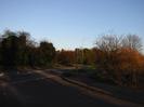 Junction with A4 Bath Road.
Low trees and bushes on both sides.