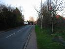 Looking north on Hitcham Road.
Trees both sides.
Lorry emerging from Bishop Centre on left.
Lamp-post on right with "KILL YOUR SPEED" sign.